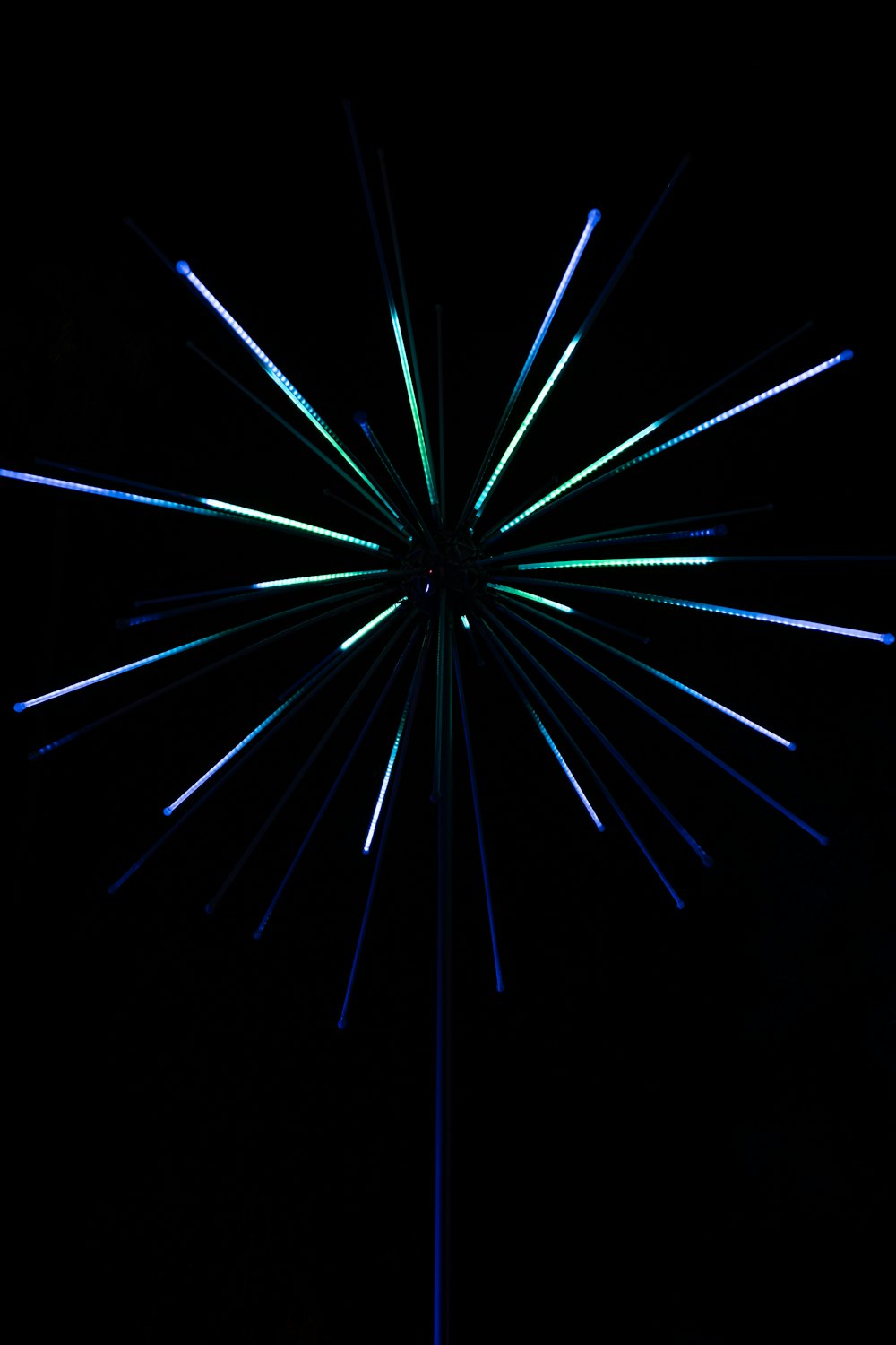 a black background with blue and green lights