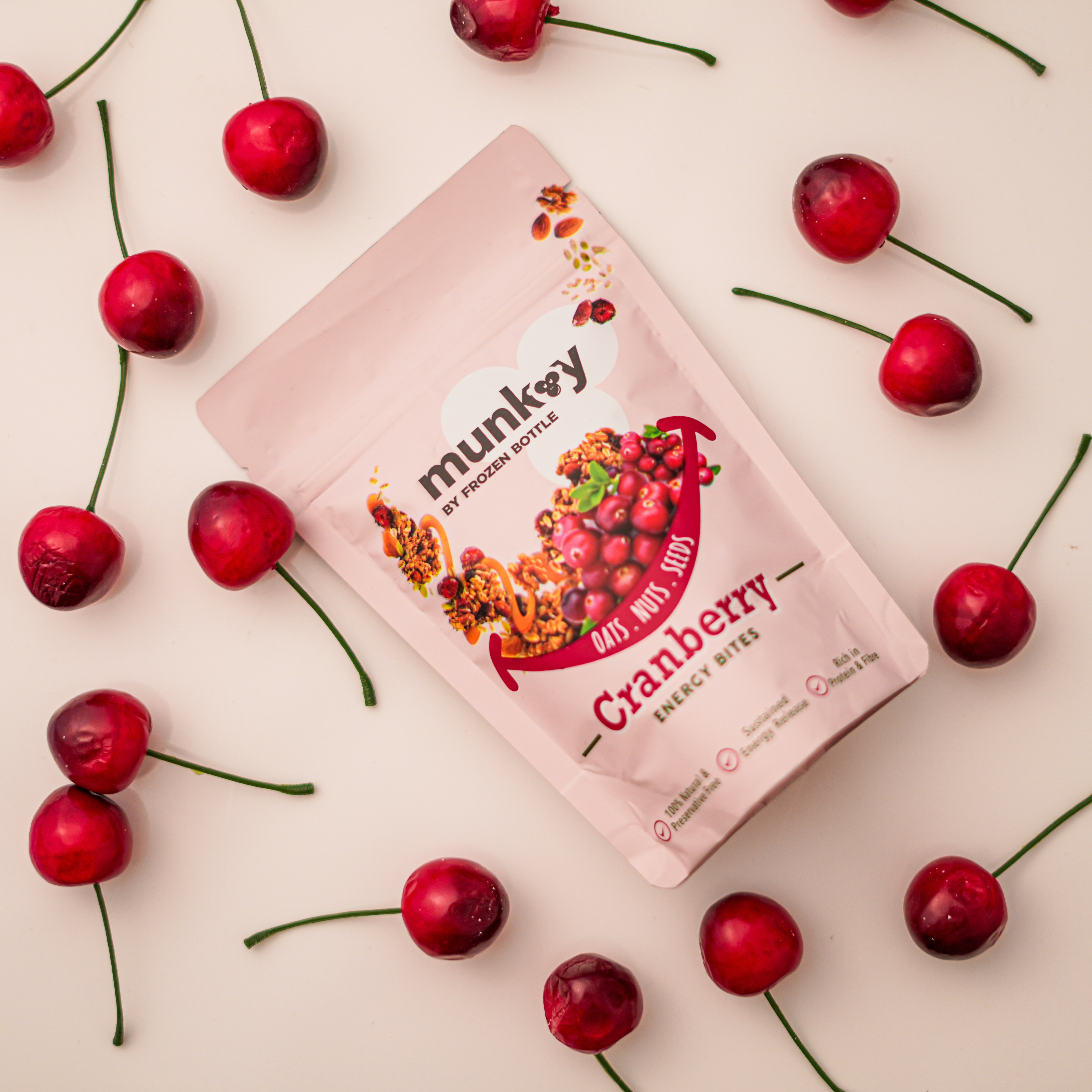 a bag of cranberry candy surrounded by cherries