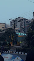 A high-quality panaflex banner displayed outside a busy storefront in Pakistan.