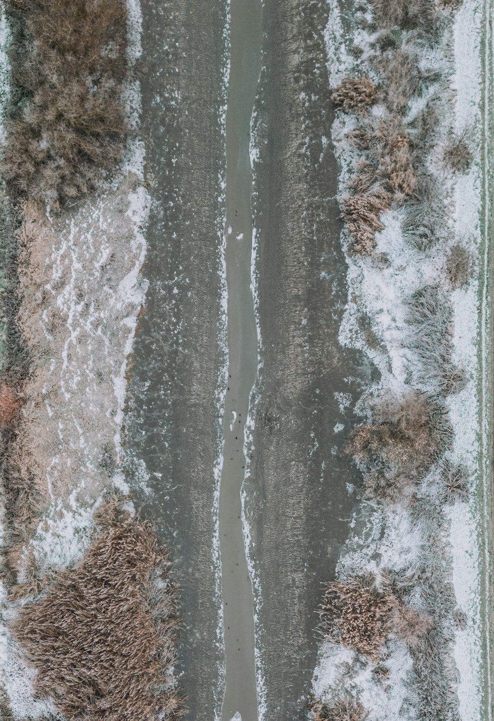 an aerial view of a snow covered road