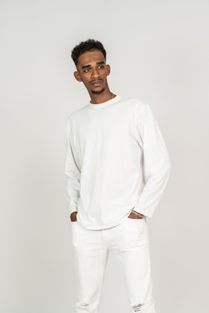 Model wearing a sleek, simple white shirt against a plain background.
