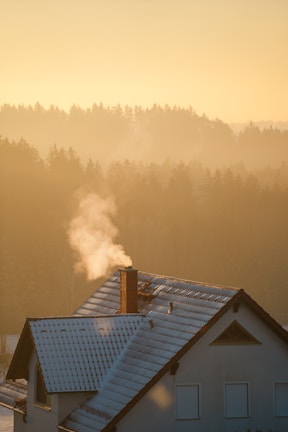 A cozy home with smoke gently rising from the chimney.