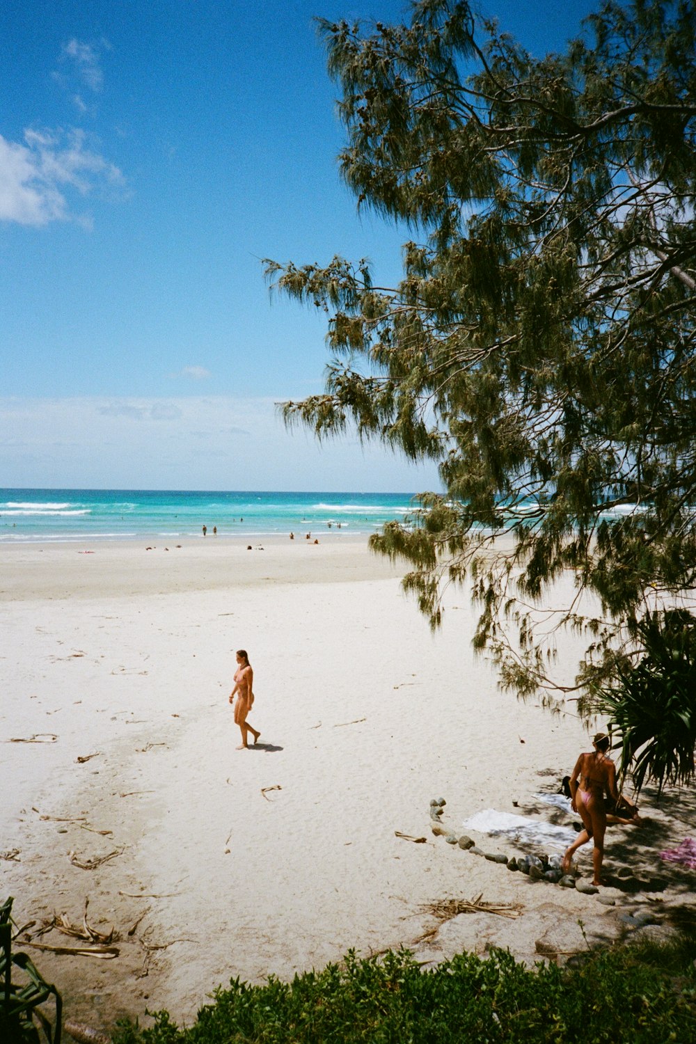 a couple of people that are standing in the sand