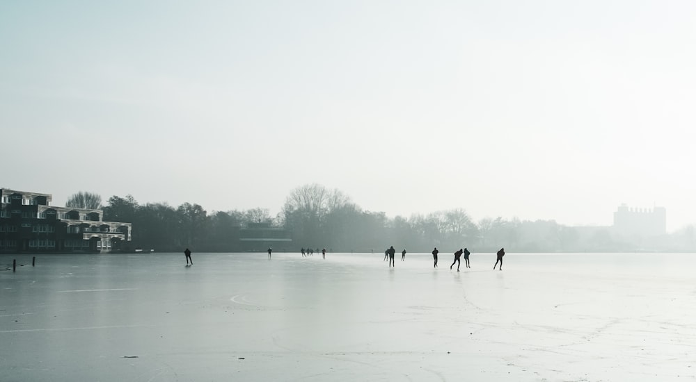 a group of people skating on a frozen lake