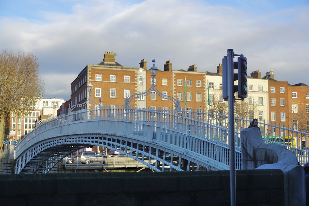 a bridge over a body of water with buildings in the background