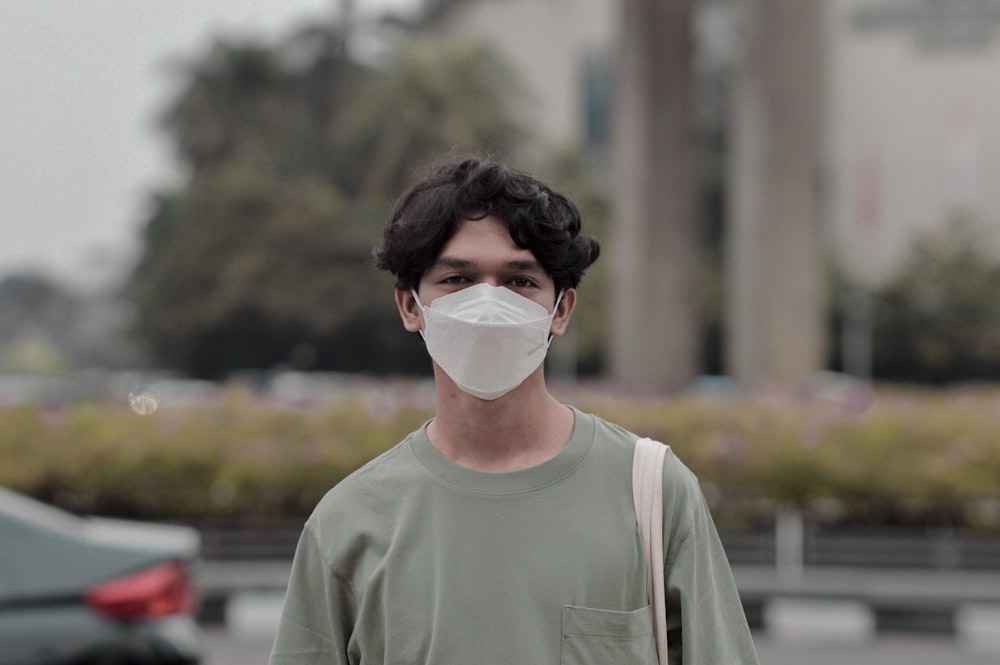 a man wearing a face mask in a parking lot