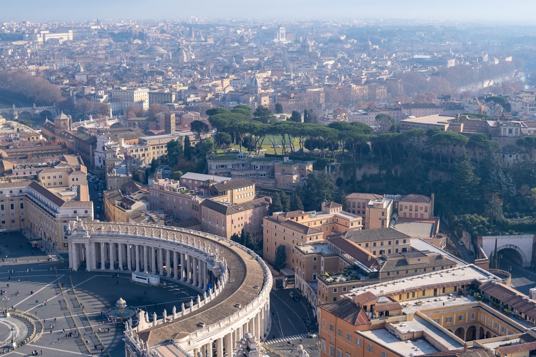 an aerial view of a city with a circular building, Shot on Fujifilm X-T3 with TTartisan 35mm f1.4