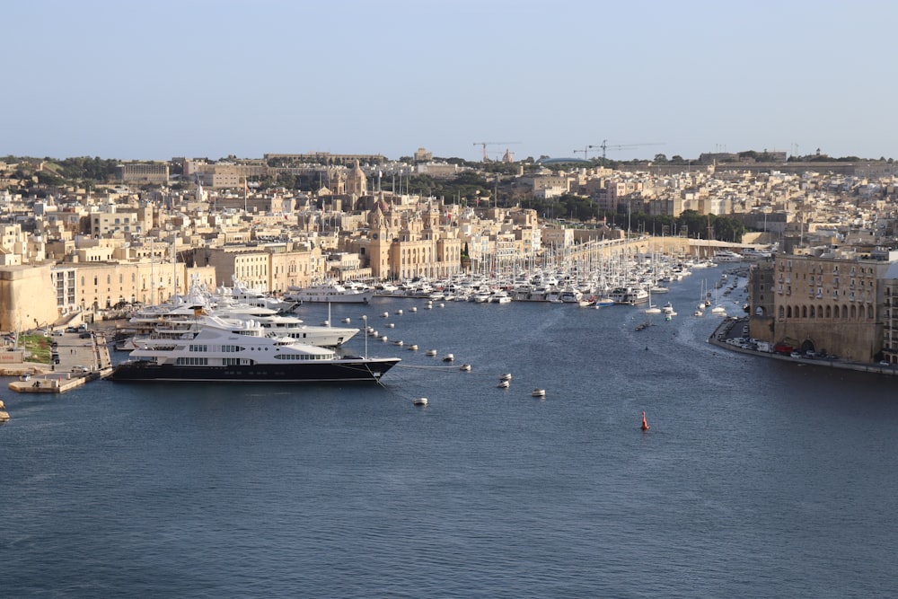 a harbor filled with lots of boats next to a city