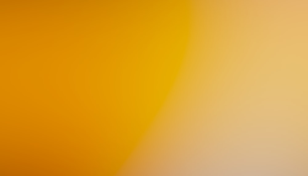 a blurry image of an orange and yellow background