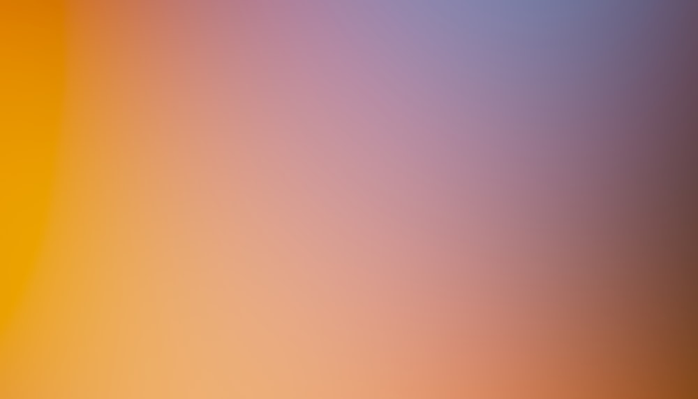 a blurry image of an orange and yellow background