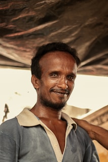 Cartoon style happy client before beard transplant, looking unsure and patchy.