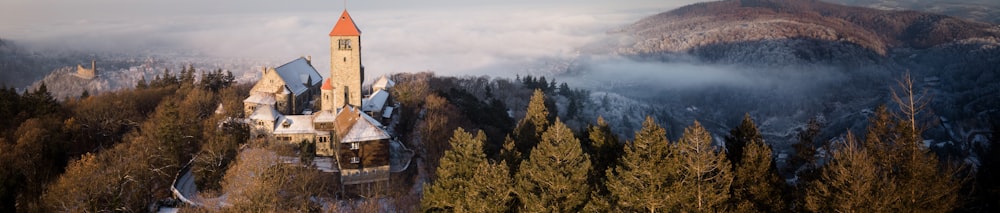 an aerial view of a church in the mountains