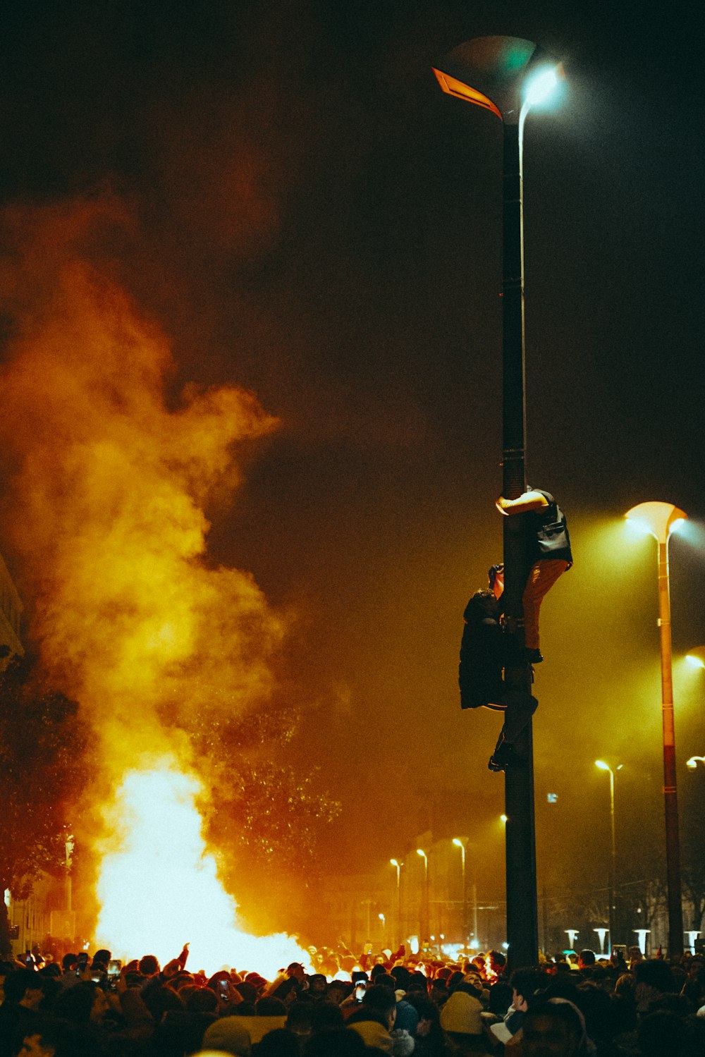 a crowd of people standing around a fire