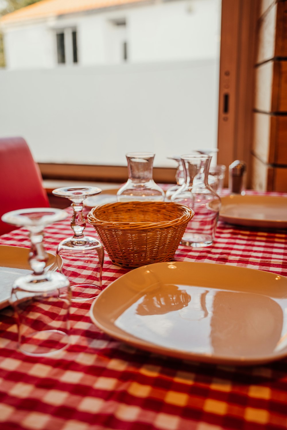 a red and white checkered table cloth with wine glasses