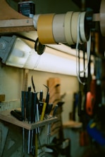 A toolbox and various handyman tools neatly arranged on a wooden workbench.