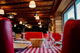 Cozy Scandinavian restaurant interior with warm lighting and rustic wooden tables set for a meal.