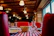 Cozy rustic Italian restaurant interior with wooden tables and warm lighting, capturing the essence of 'la bussola'