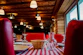 Cozy rustic Italian restaurant interior with wooden tables and warm lighting, capturing the essence of 'la bussola'