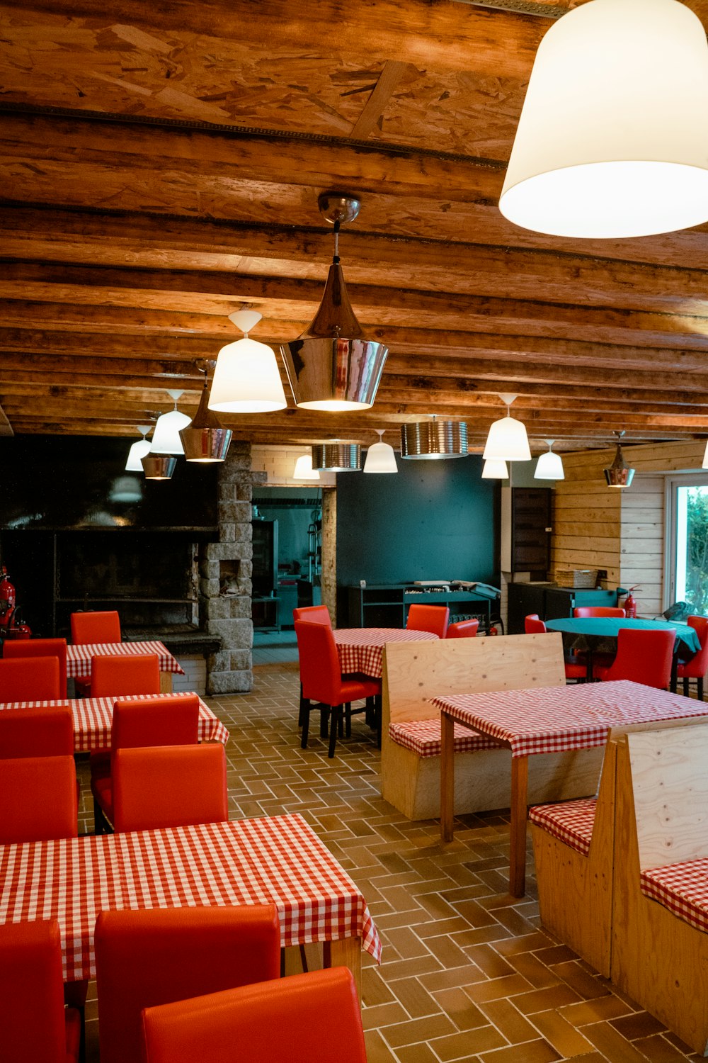 a restaurant with red and white checkered tables and chairs