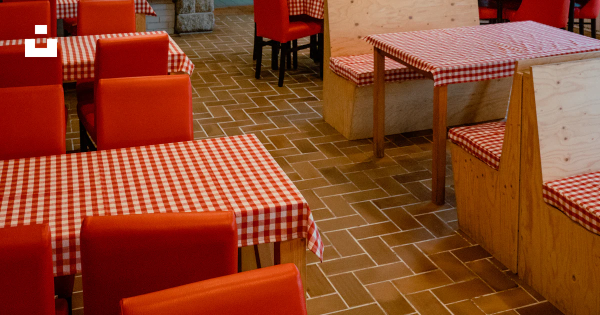 A restaurant with red and white checkered tables and chairs photo ...