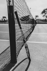 a black and white photo of a tennis net