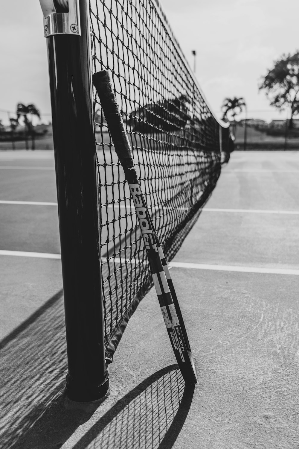 a black and white photo of a tennis net
