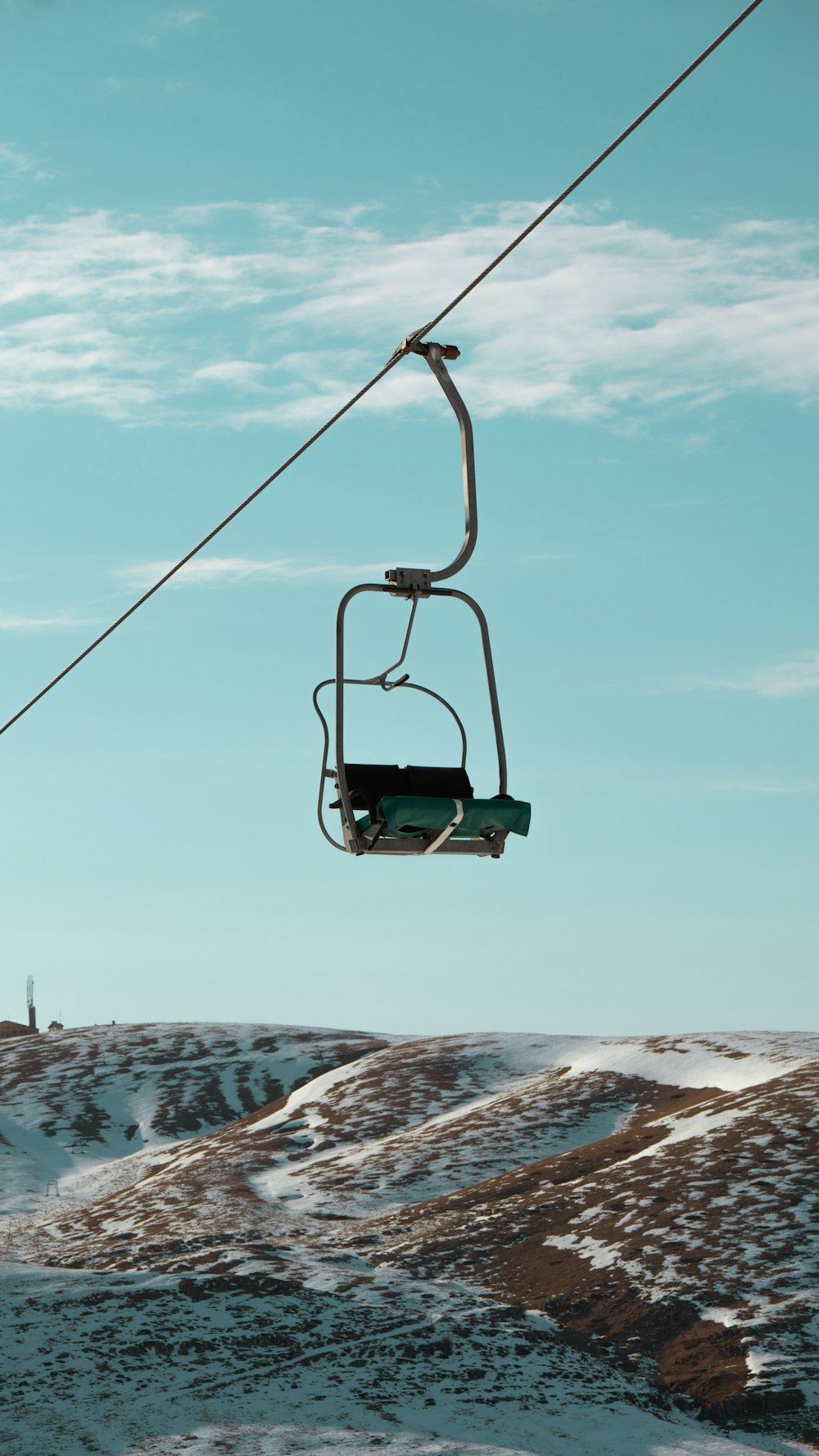 a ski lift going up a snowy mountain