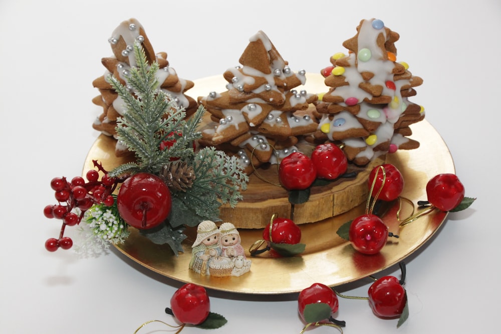 a plate of cookies and cherries on a table