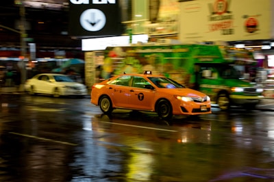 A yellow cab cruising through the bustling streets of a Punjab city during sunset.