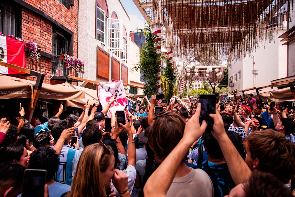 a crowd of people standing around each other