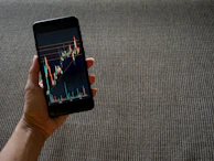 Warm, cinematic photo of a trader analyzing signals with a terracotta-toned background.