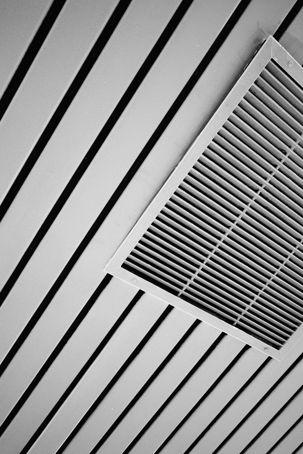 a black and white photo of a ceiling vent