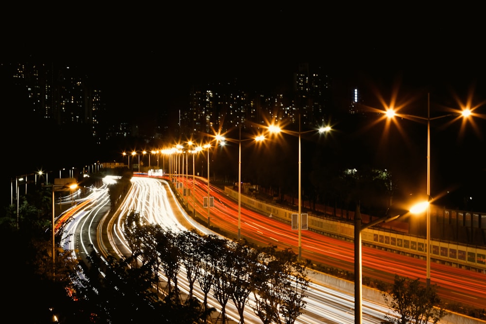 a city street filled with lots of traffic at night