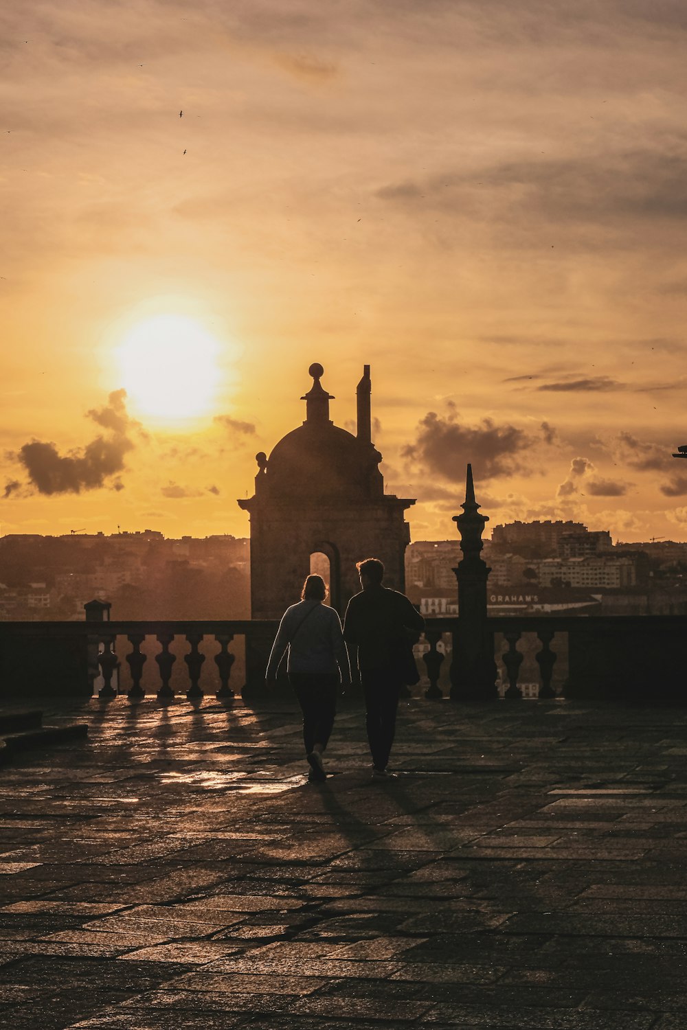 a couple of people walking across a bridge