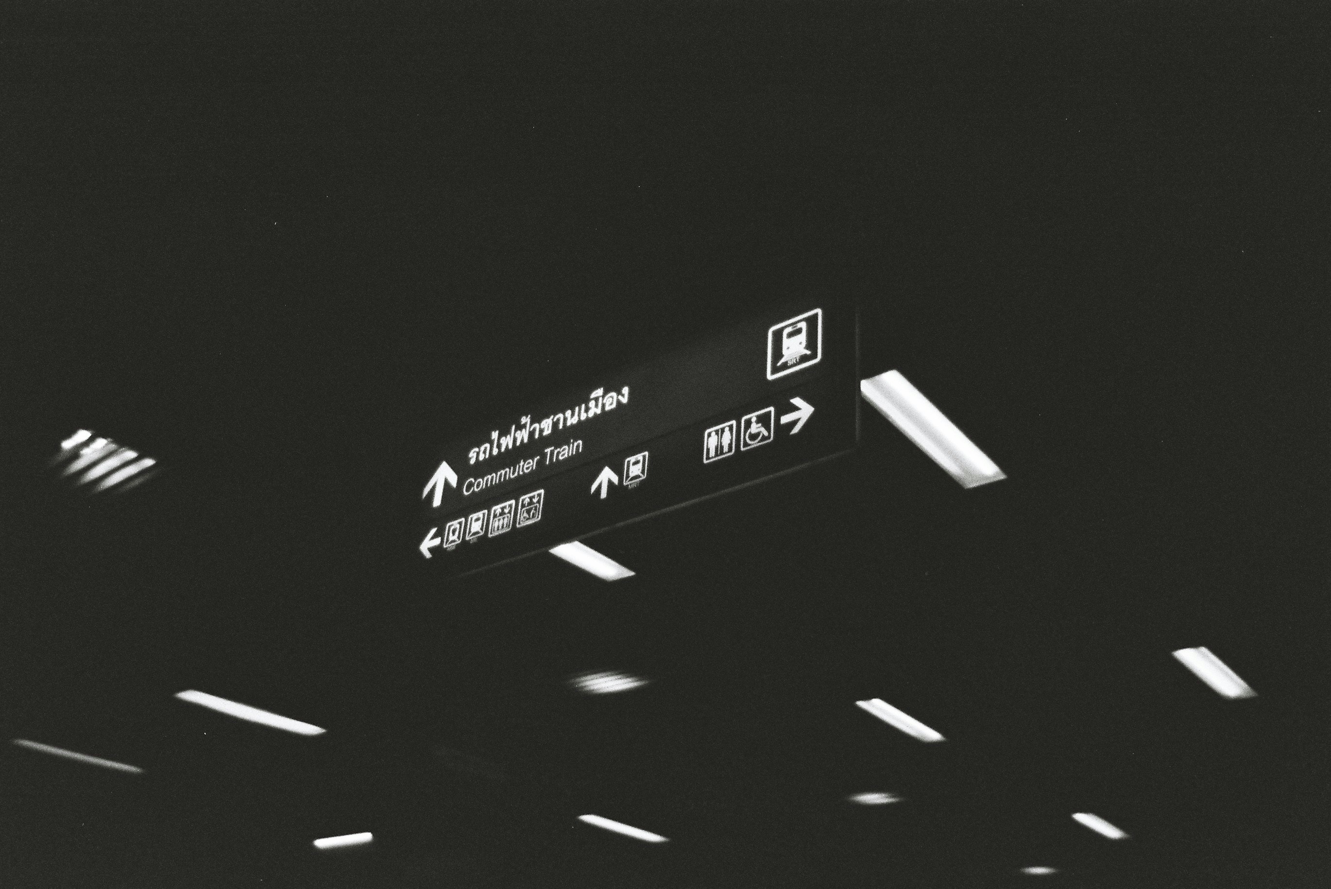 a black and white photo of an airport sign