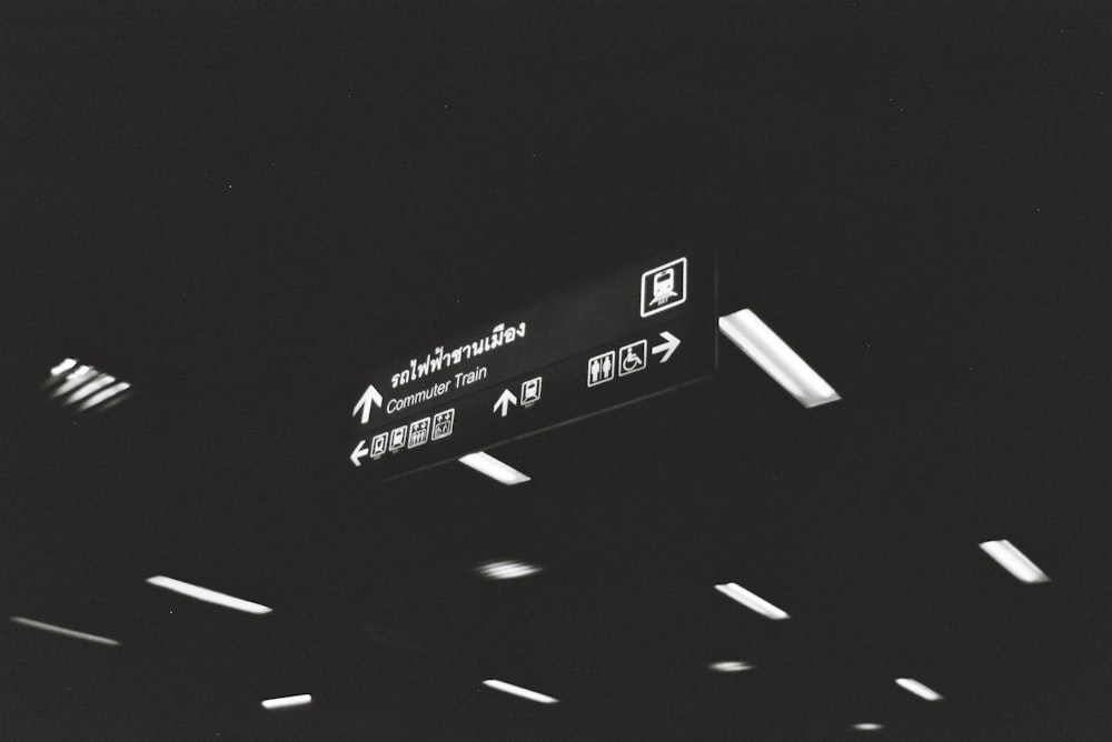 a black and white photo of an airport sign