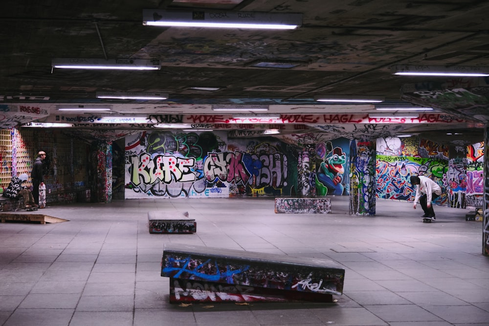 a skateboard park with graffiti all over the walls