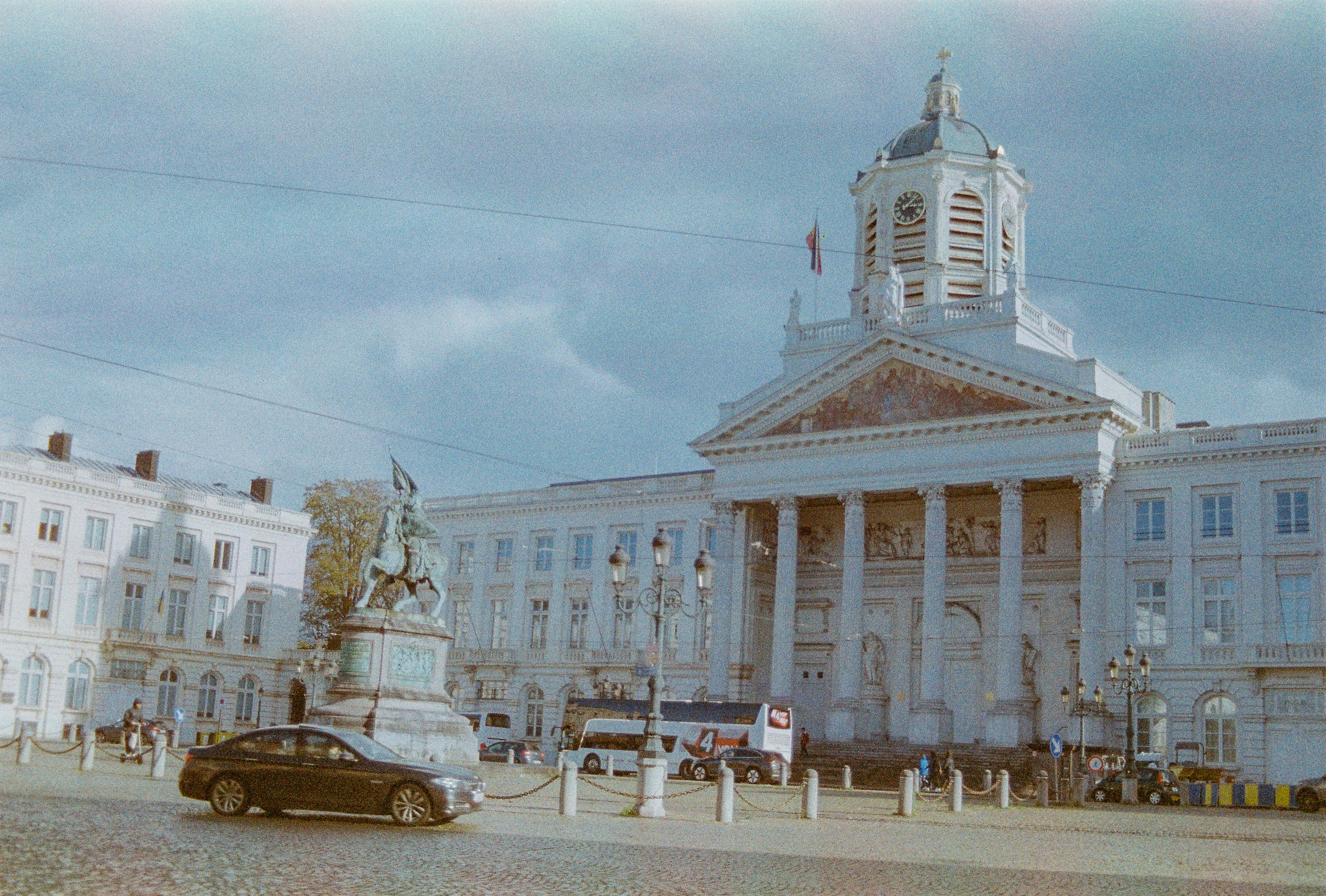 a car is parked in front of a large building