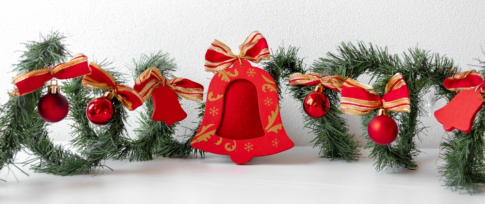 a row of christmas decorations with bells and bows