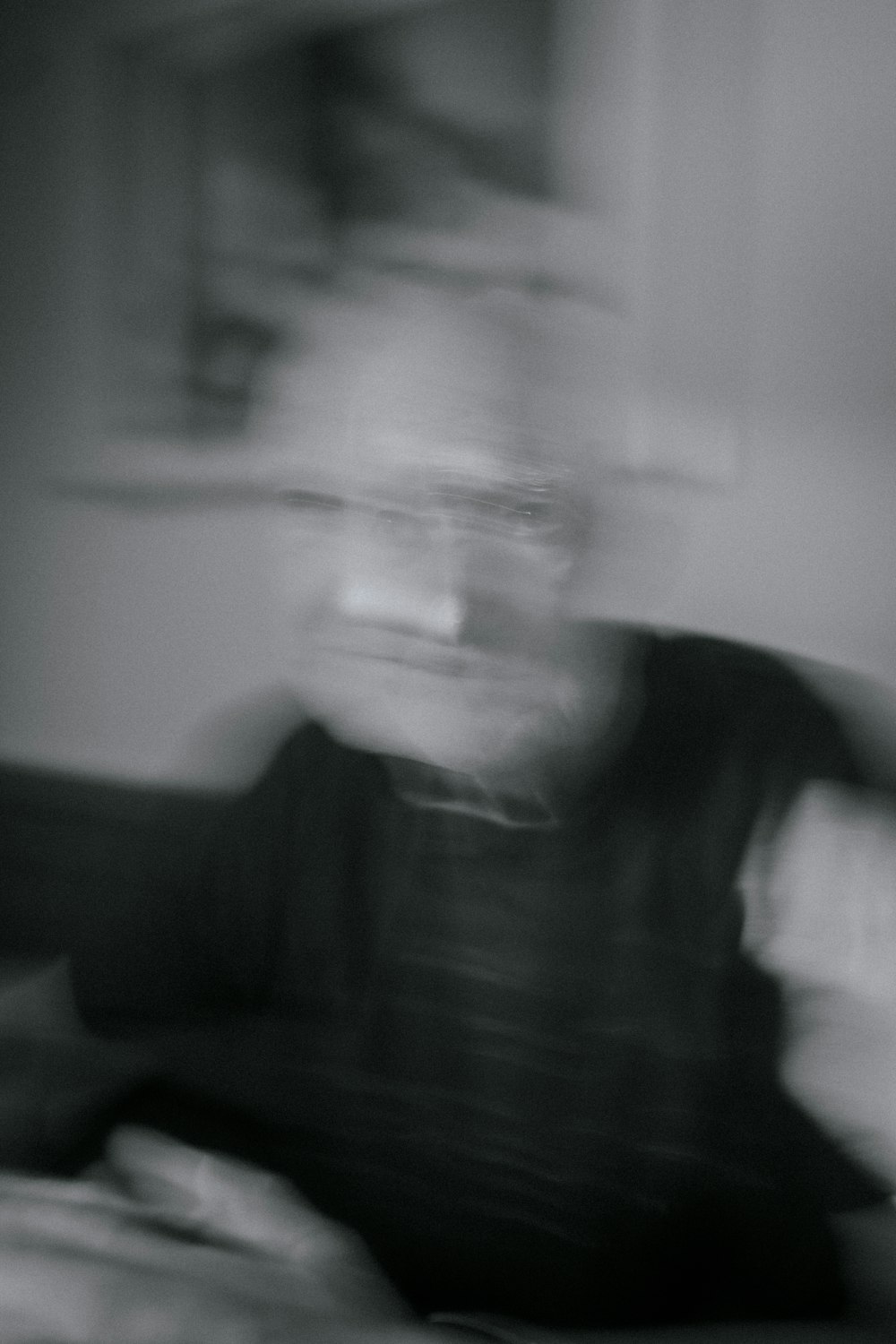 a blurry photo of a person sitting on a bed