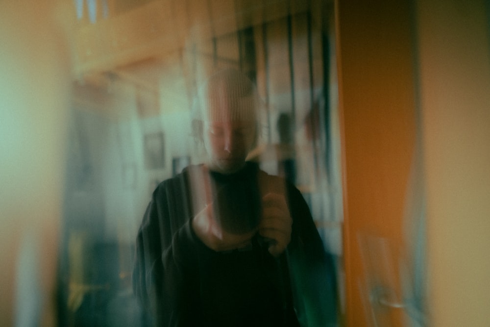 a blurry photo of a person holding a cell phone