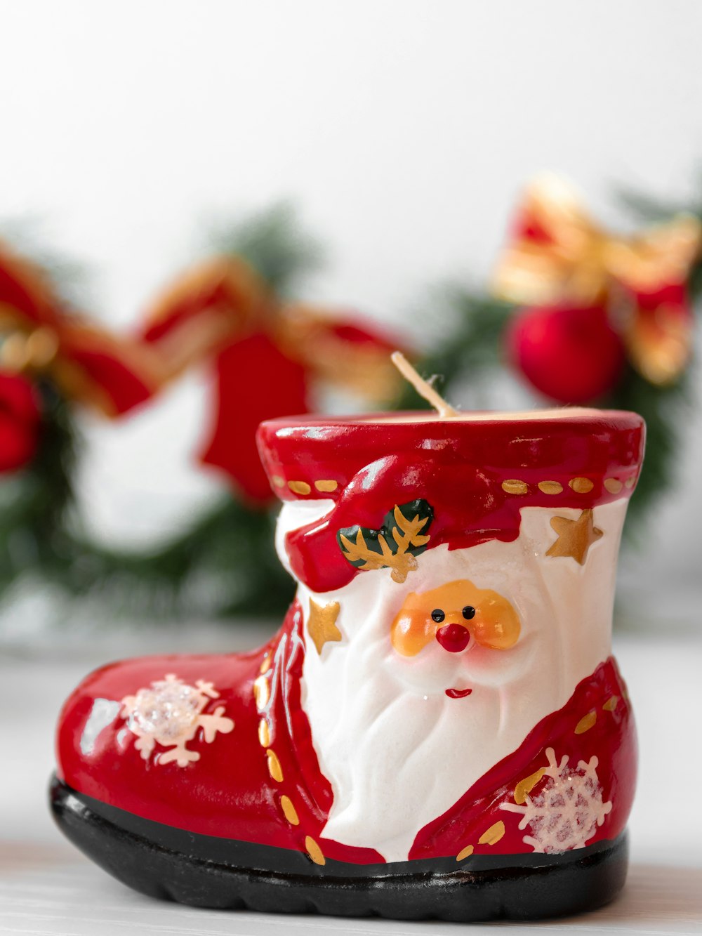 a red and white santa claus boot ornament