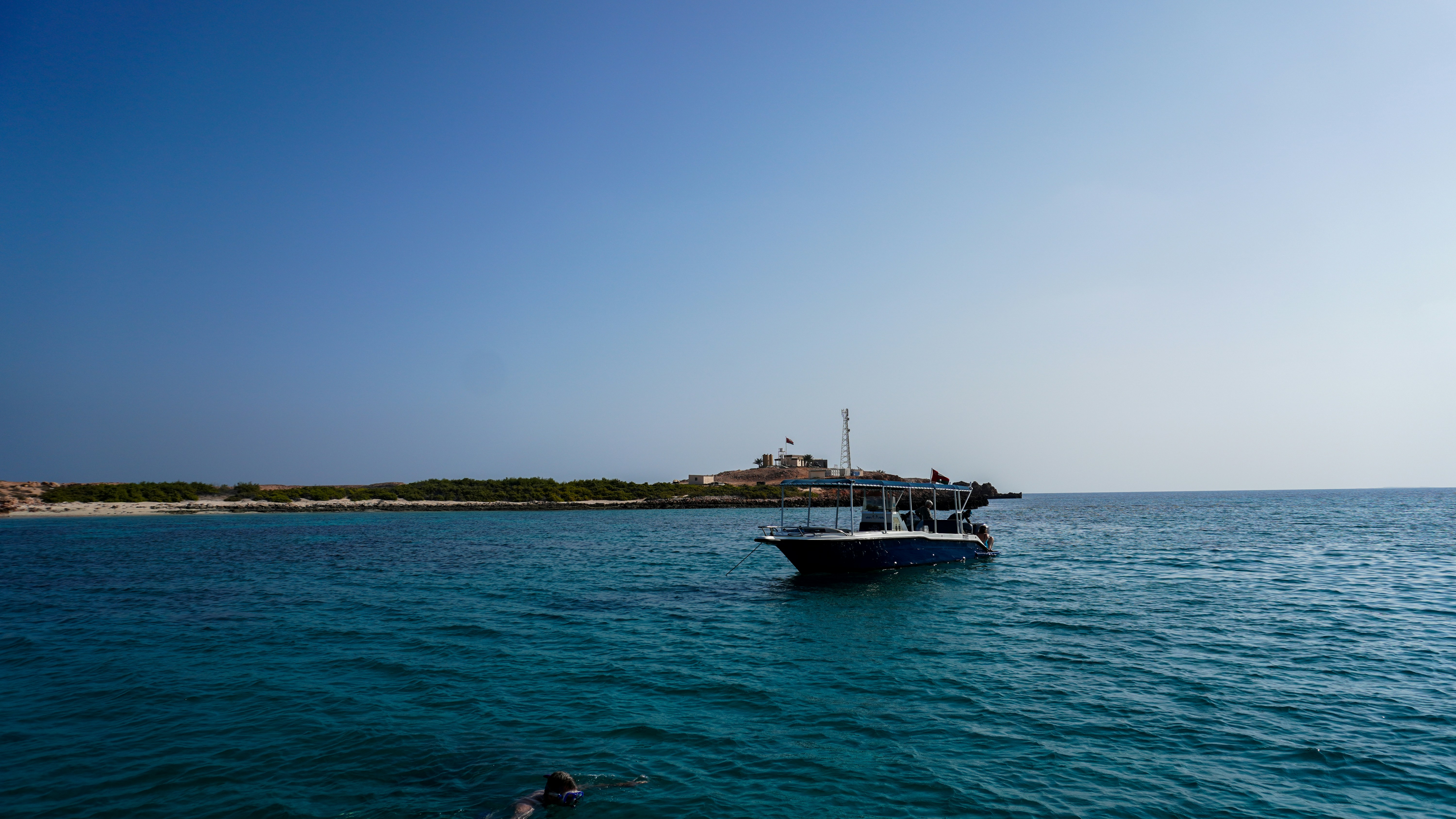 a boat floating in the middle of a body of water