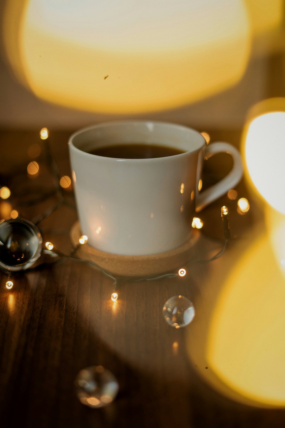 a cup of coffee sitting on top of a wooden table