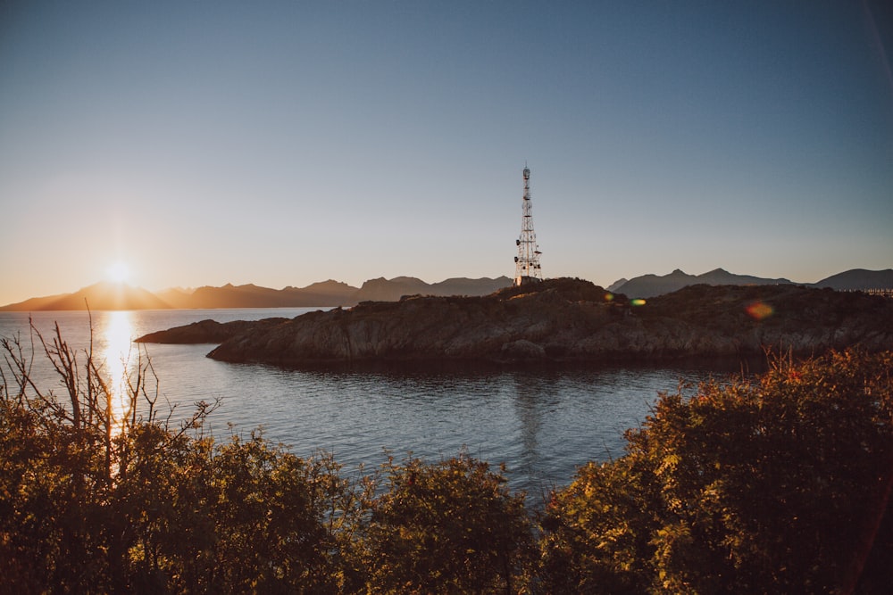 the sun is setting over a body of water