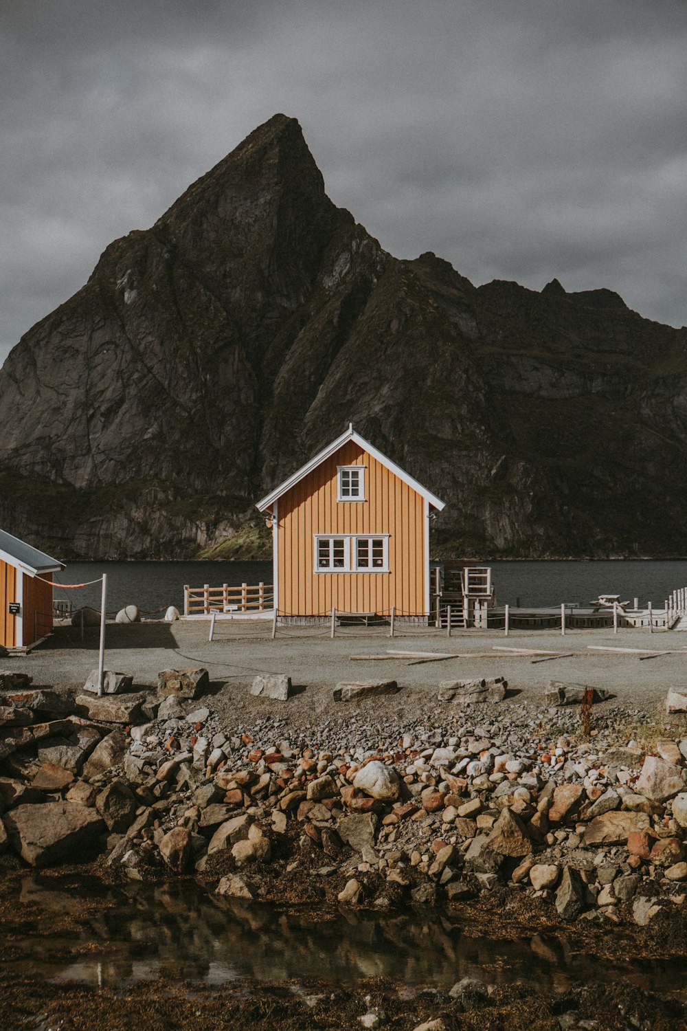 a couple of houses sitting next to a body of water