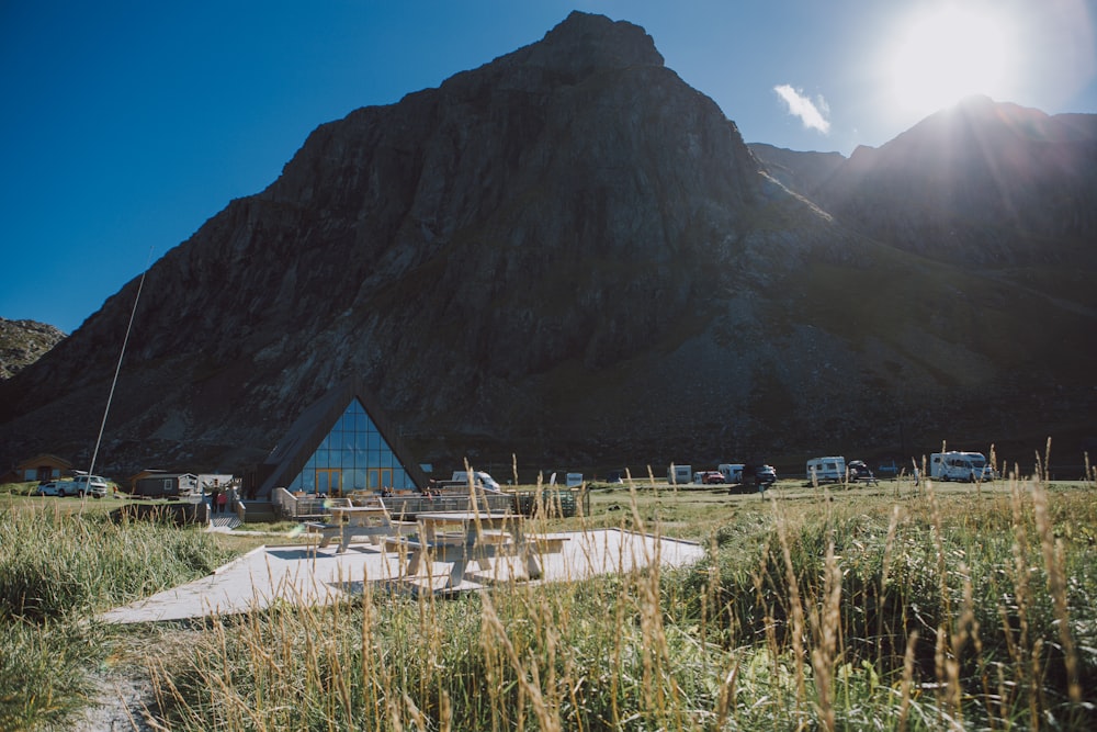 a tent set up in a field with a mountain in the background
