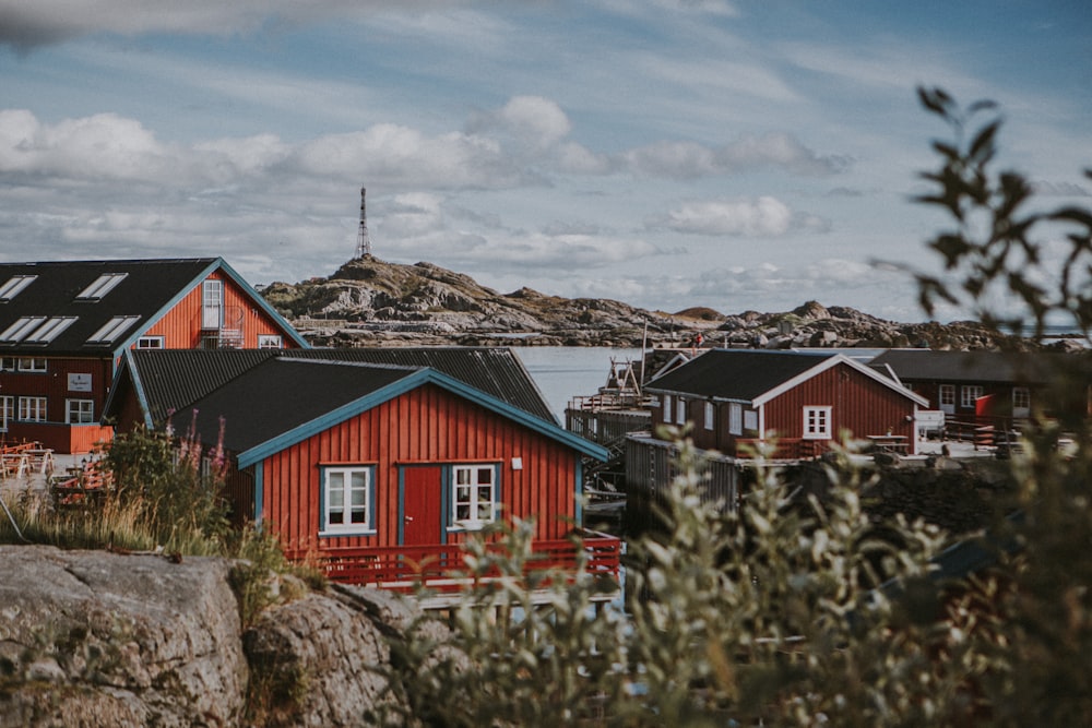 a group of houses sitting next to a body of water