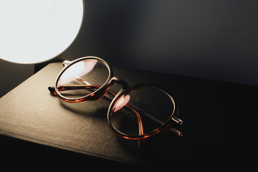 a pair of glasses sitting on top of a table