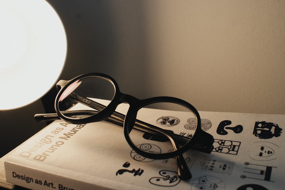 a pair of glasses sitting on top of a book